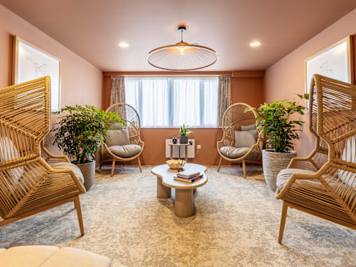 A living room with a round table and four chairs.