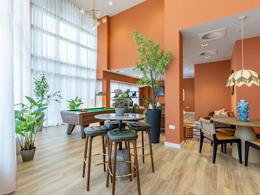 A room with orange walls and a pool table.