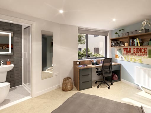 A bathroom with a white sink and a mirror, a desk with a chair, and a window with a view of trees.