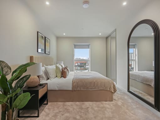 A bedroom with a large bed and a view of the city.