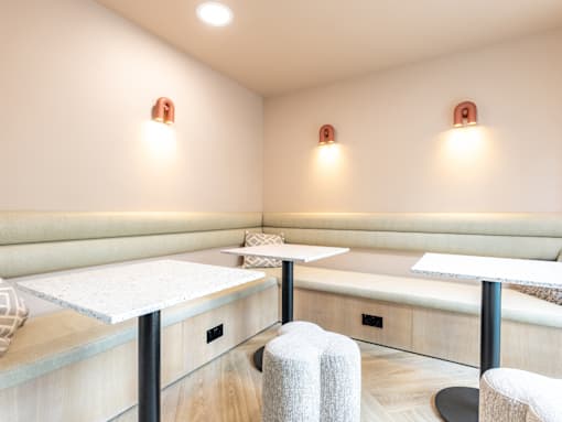 A room with a white table and two chairs.