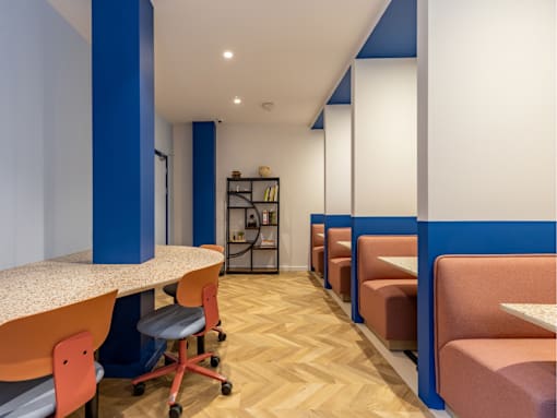 A room with a long table and chairs.