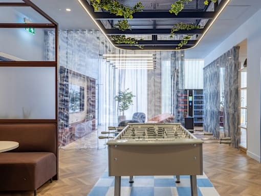 A room with a long table and a sofa.