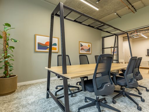 A conference room with a long table and chairs.