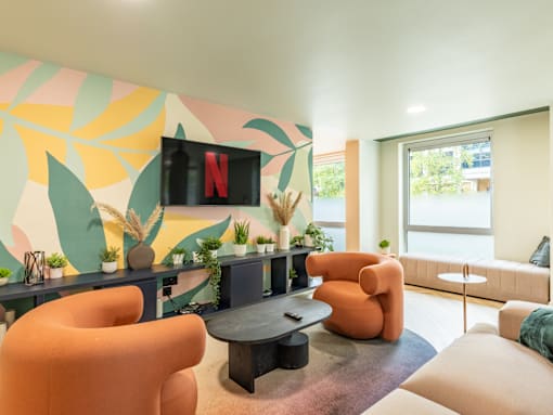 A living room with a TV displaying the Netflix logo.