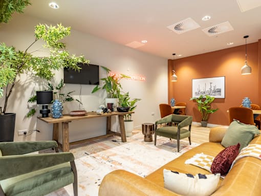 A living room with a brown couch and a wooden table.