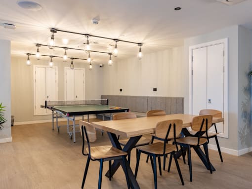 a conference room with tables and chairs and a ping pong table