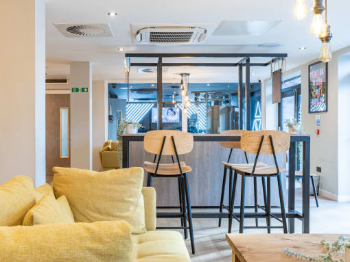 a living room with a bar and a couch