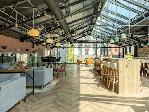 A modern interior with a glass ceiling and wooden floors.