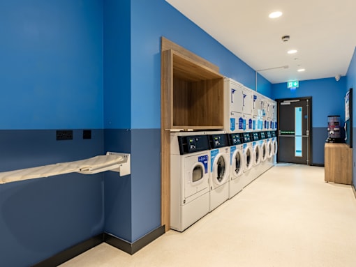 A row of washing machines in a laundromat.