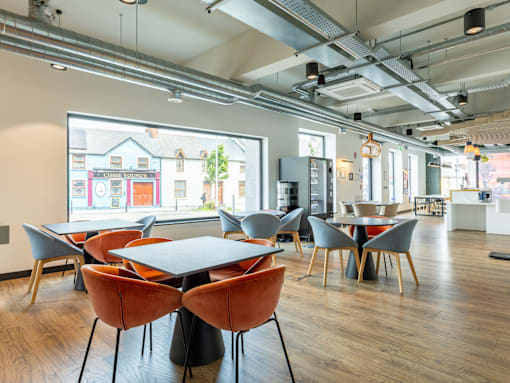 A conference room with a long table and chairs.