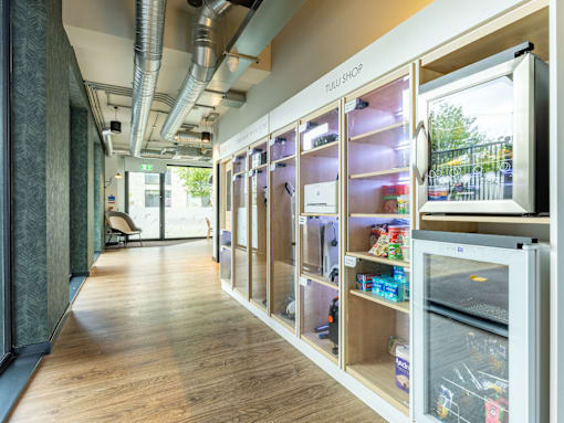 A modern kitchen with a large refrigerator and wooden floors.