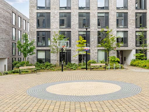 A basketball court is located in front of a building.
