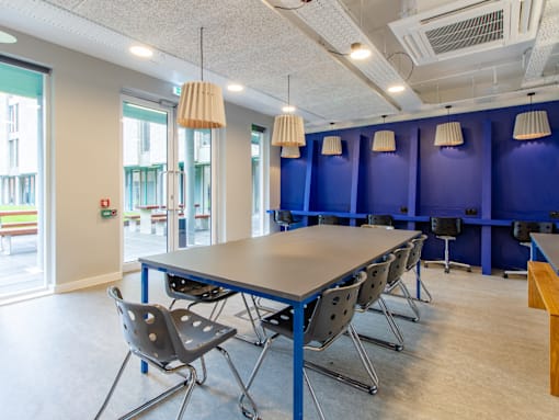 A conference room with a long table and chairs.