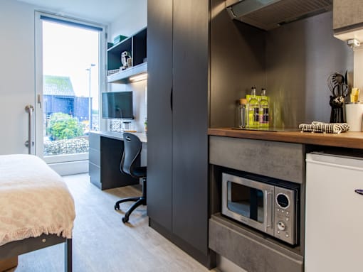 A modern kitchen with a built-in oven and microwave.