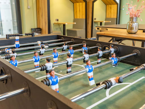 A foosball table with blue and white players.