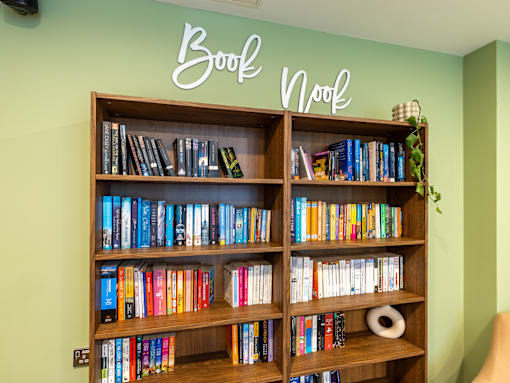 A bookshelf filled with books under a sign that says Book Nook.