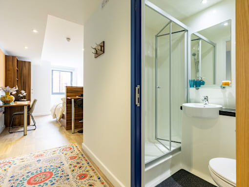 A bathroom with a white sink and a blue door.