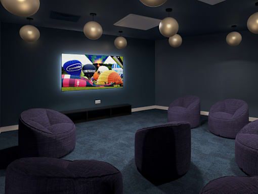A room with purple chairs and a television displaying a colorful image.