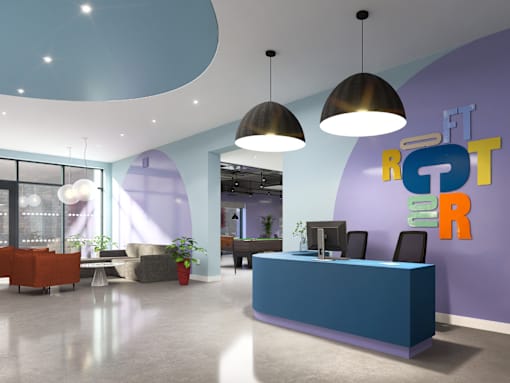 A reception area with a blue counter and a purple wall with the letters "FT" and "R" on it.