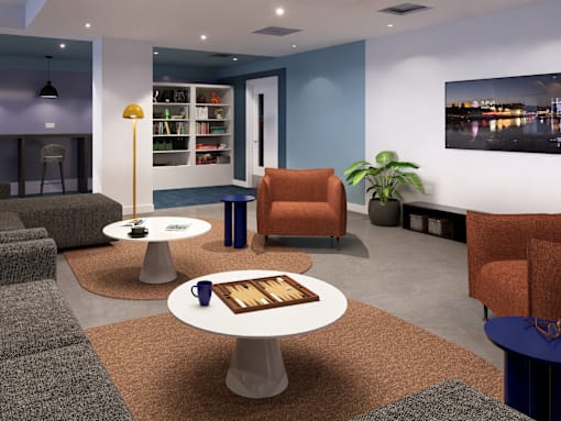 A modern living room with a grey sofa, orange armchair, and a coffee table with a wooden tray on it.