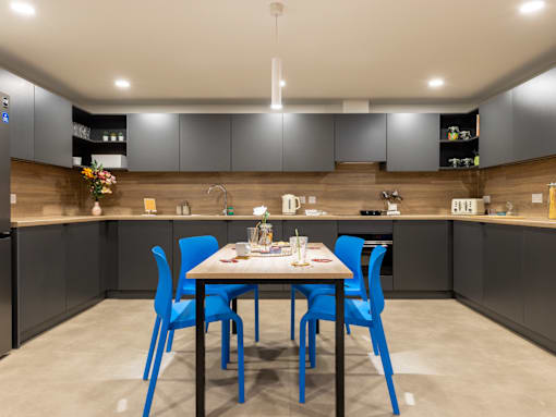 A modern kitchen with a dining table set for four.