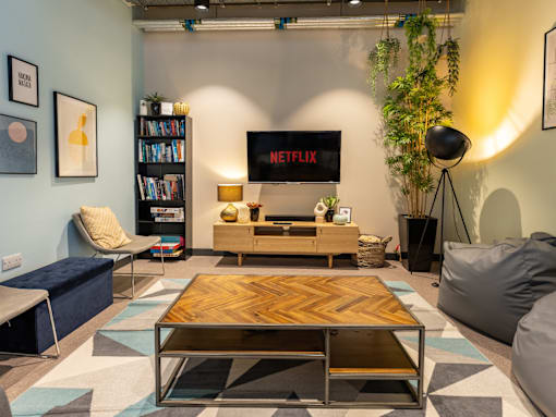 A living room with a Netflix screen on the wall.