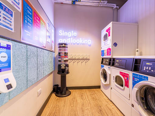 A laundromat with a sign that says Single and looking.