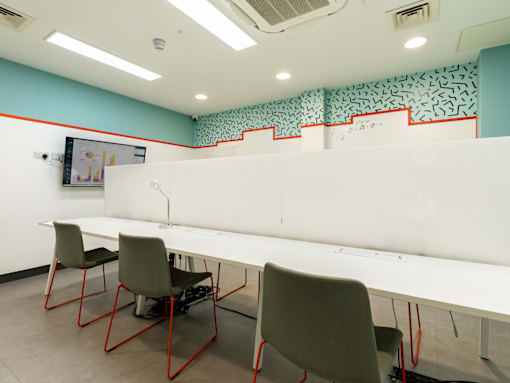 A room with a white table and chairs.