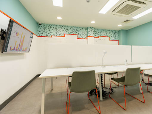 A conference room with a long table and chairs.