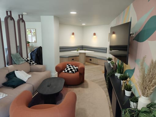 A living room with a couch, chair, and a table.