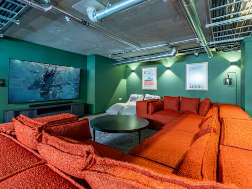 A room with a green wall and a television.