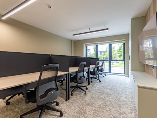 A conference room with a long table and chairs.