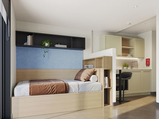 A bedroom with a bed, a desk, and a chair.
