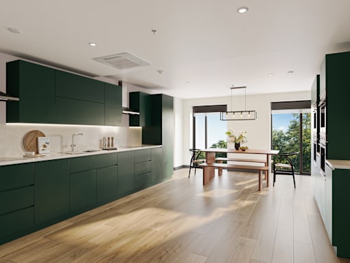 A modern kitchen with dark green cabinets and wooden flooring.
