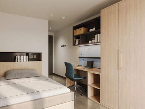 A bedroom with a bed, desk, and chair.