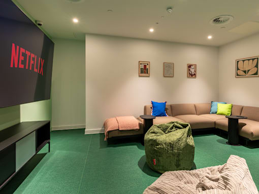 A Netflix branded room with a couch and bean bag chair.