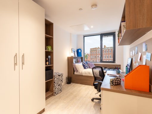 a home office with a desk and a couch in a window