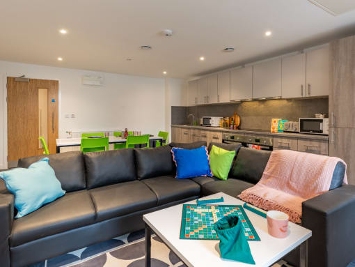 a living room with couches and a table with a chess board