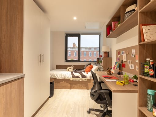 a small room with a desk and a bed