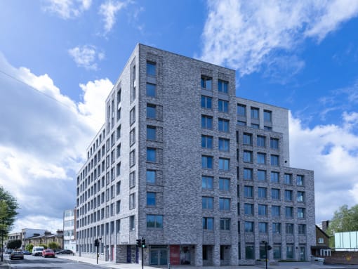 a large brick building with many windows on a city street