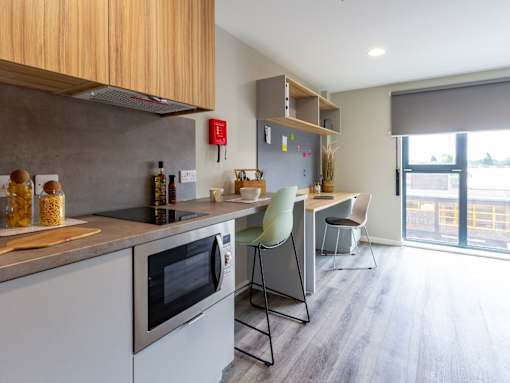 A modern kitchen with a grey countertop and a grey oven.