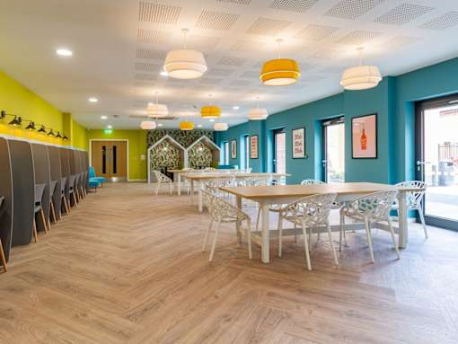 A room with a long table and chairs.