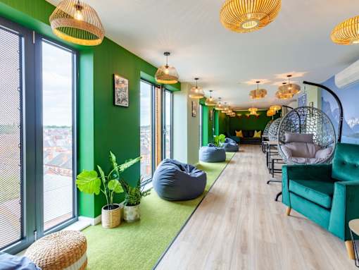 A room with green walls and a long wooden floor.