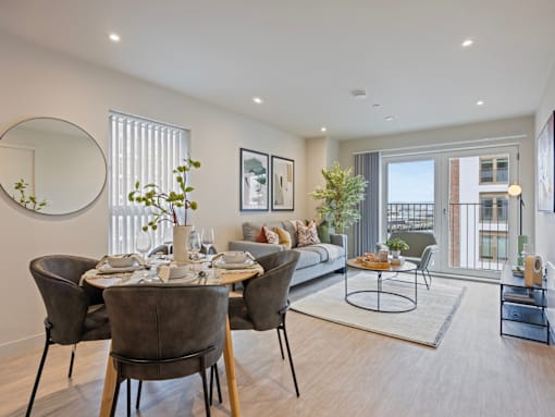 A modern dining room with a round table and chairs.