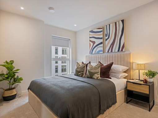 A bedroom with a large bed and a window.