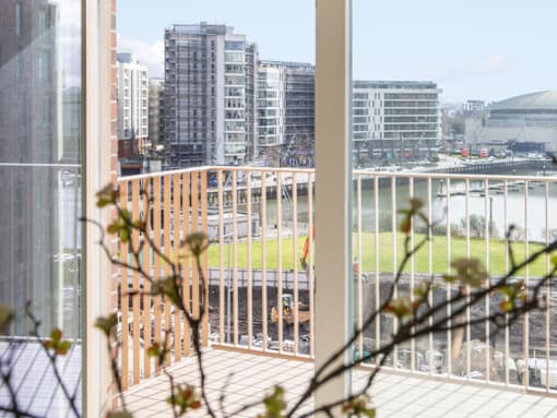 A view from a balcony looking out at a cityscape.