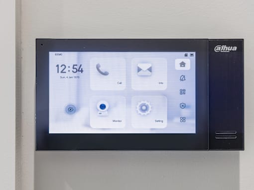 A black Alhua monitor displays the time as 12:54 and icons for call, email, and settings.