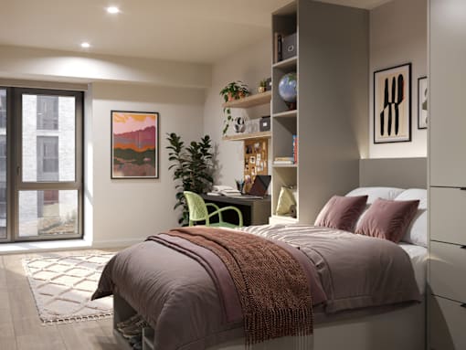 A bedroom with a bed, desk, and chair.