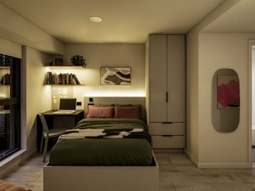 A bedroom with a bed, desk, and chair.